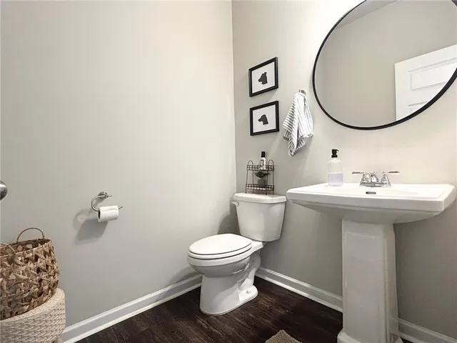 a bathroom with a sink toilet and a mirror