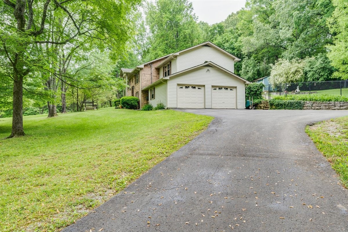 7418 Chester Road Fairview, TN 37062 - Photo 3 of 48 a view of a house with a yard and large trees