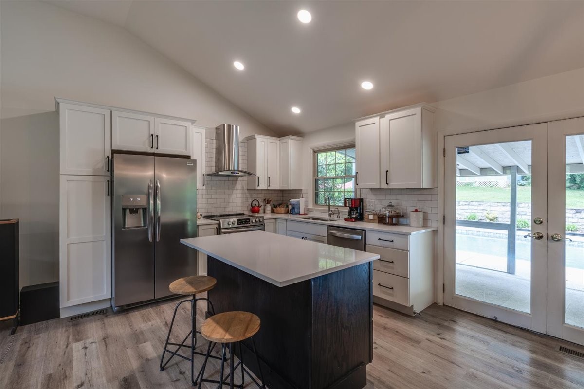 7418 Chester Road Fairview, TN 37062 - Photo 9 of 48 a kitchen with refrigerator cabinets dining table and chairs