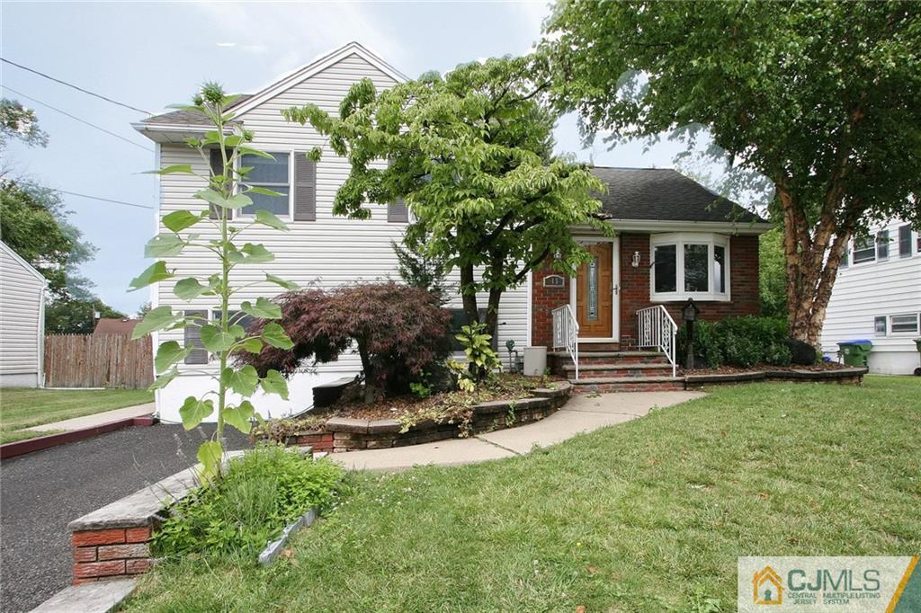 15 Leland Road Edison, NJ 08817 - Photo 1 of 25 a front view of a house with a garden and sitting area
