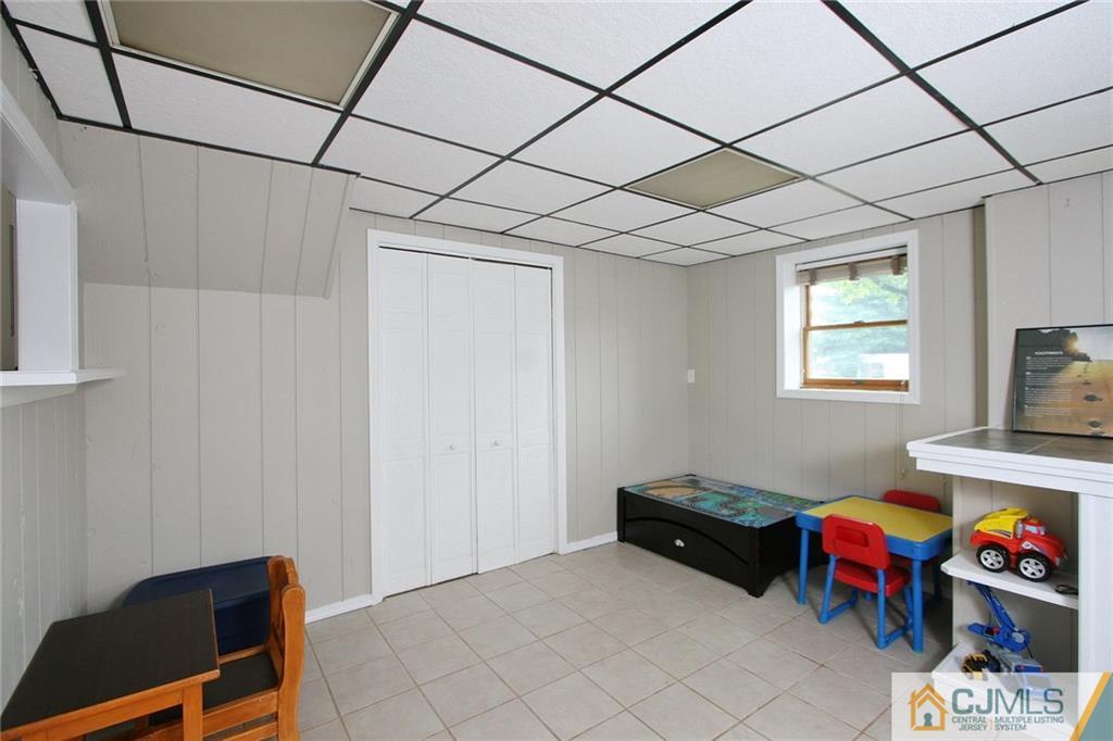 15 Leland Road Edison, NJ 08817 - Photo 12 of 25 a living room with furniture a flat screen tv and a window