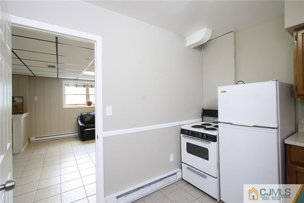 15 Leland Road Edison, NJ 08817 - Photo 15 of 25 a white refrigerator freezer and a stove sitting inside of a kitchen