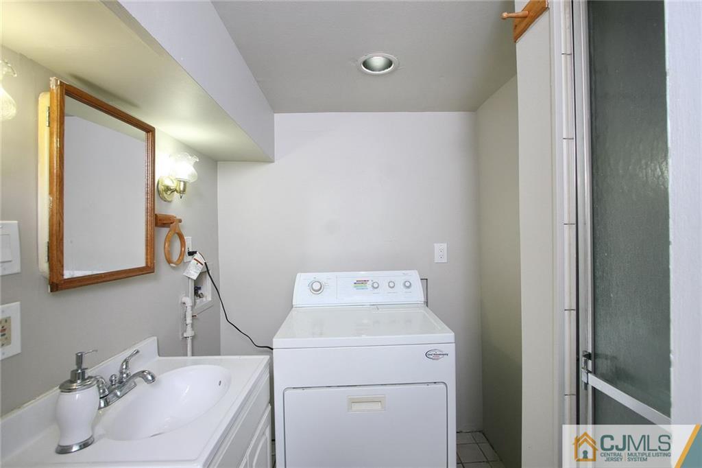 15 Leland Road Edison, NJ 08817 - Photo 17 of 25 a bathroom with a sink and a mirror