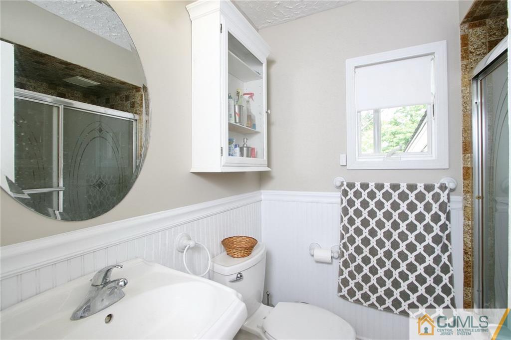 15 Leland Road Edison, NJ 08817 - Photo 21 of 25 a bathroom with a sink toilet and mirror