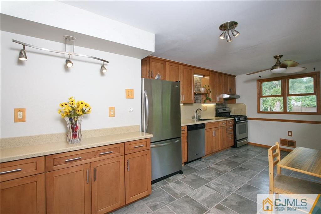 15 Leland Road Edison, NJ 08817 - Photo 8 of 25 a kitchen with stainless steel appliances a refrigerator sink and cabinets
