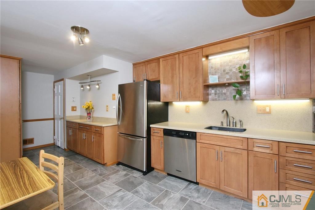 15 Leland Road Edison, NJ 08817 - Photo 10 of 25 a kitchen with a sink cabinets and refrigerator