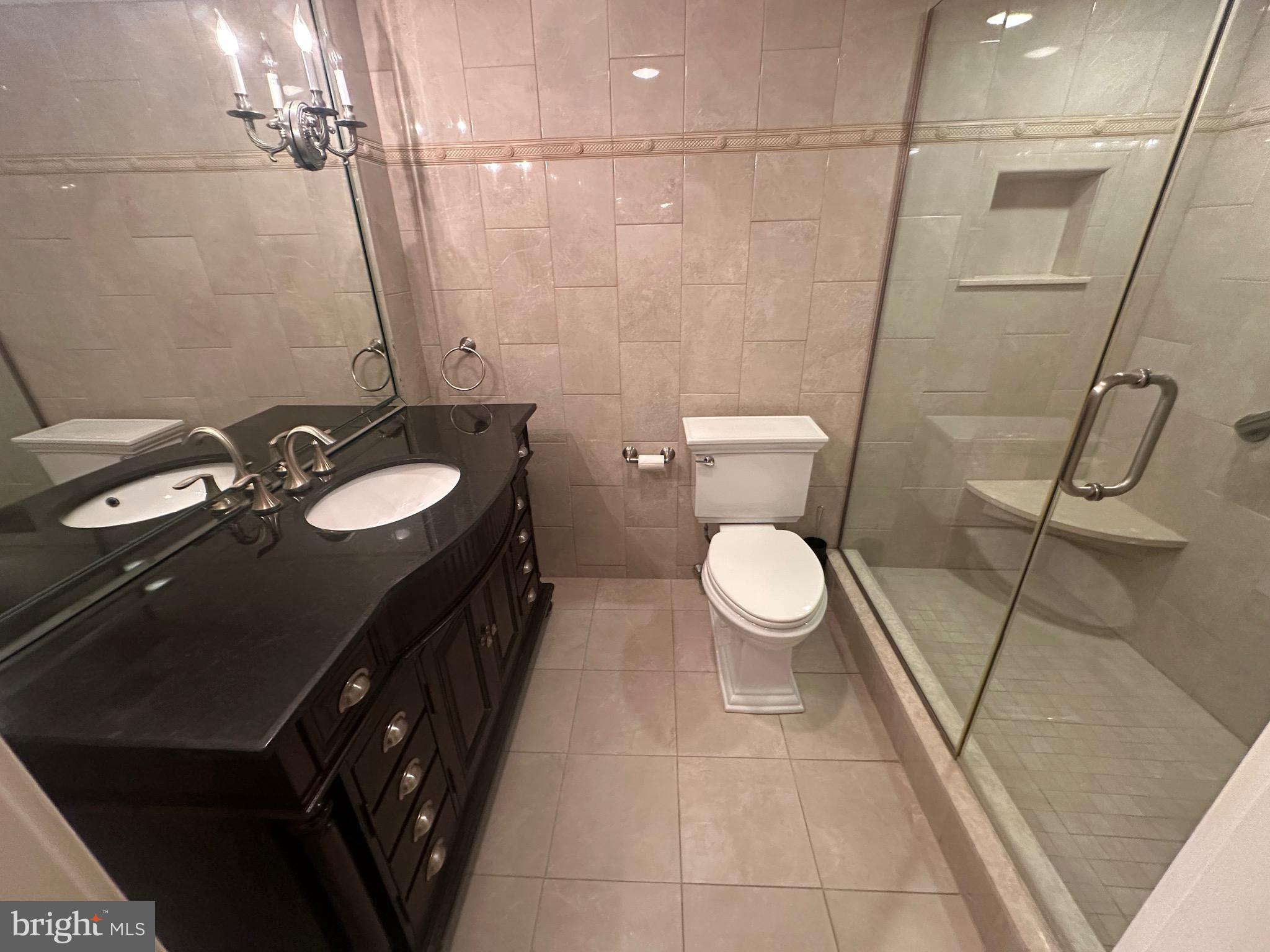 41 Conshohocken State Road, Unit 109 Bala Cynwyd, PA 19004 - Photo 11 of 23 a bathroom with a double vanity sink toilet and a mirror