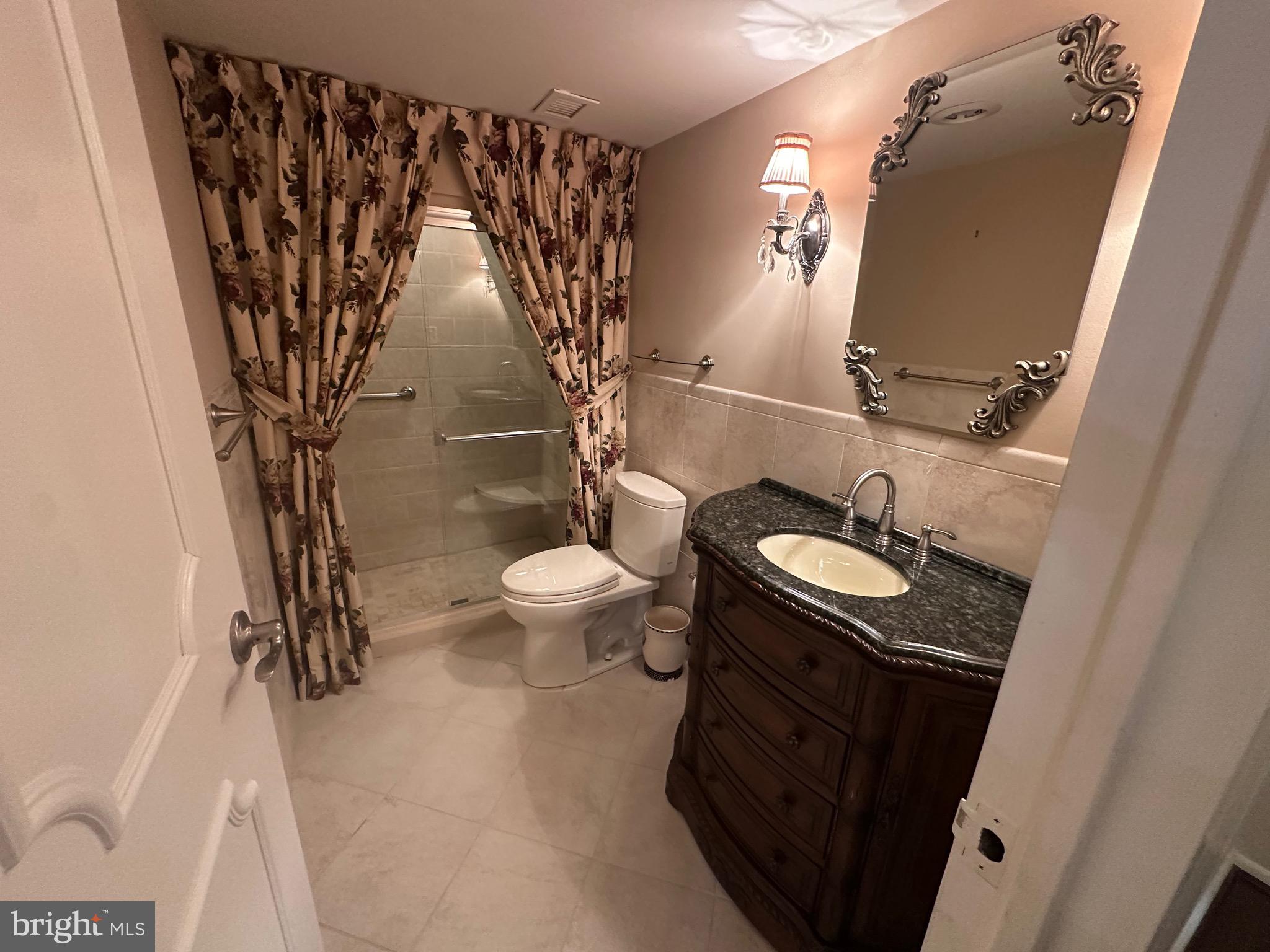 41 Conshohocken State Road, Unit 109 Bala Cynwyd, PA 19004 - Photo 13 of 23 a bathroom with a granite countertop sink and a mirror