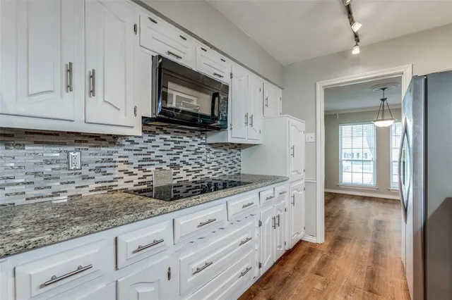 a kitchen with stainless steel appliances granite countertop a stove and a sink