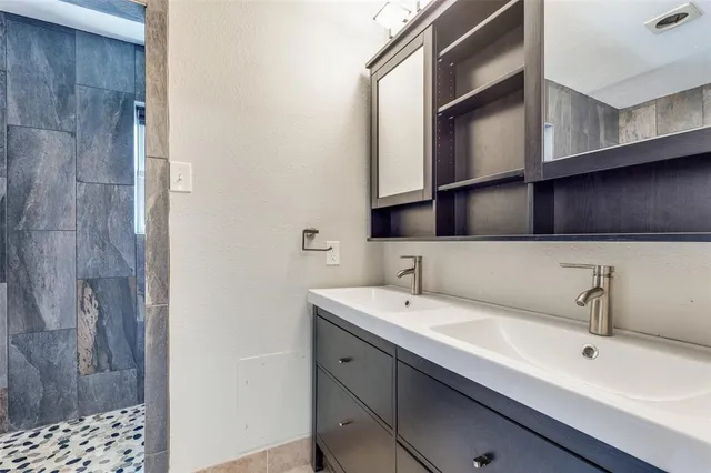 a bathroom with a bathtub and shower
