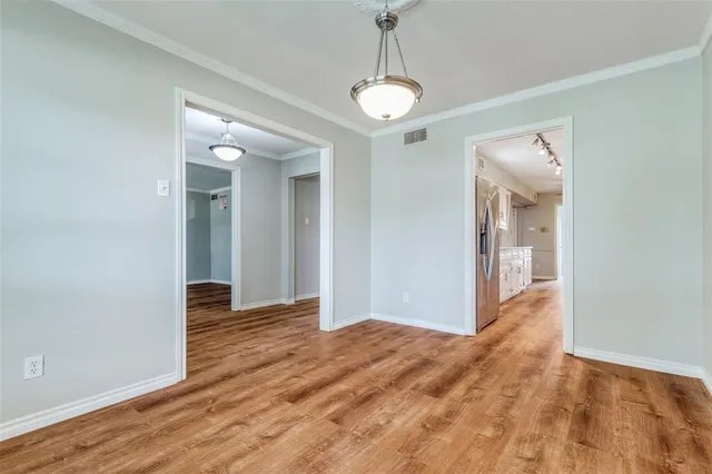 a view of hallway with wooden floor