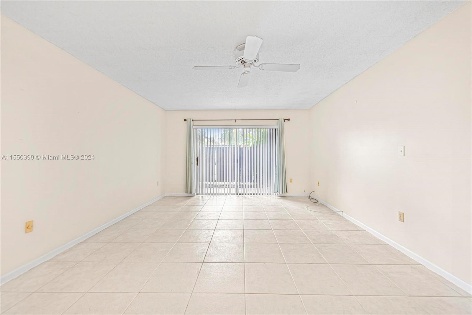 9107 Southwest 137th Terrace, Unit 14 Miami, FL 33186 - Photo 11 of 25 a view of an empty room with a window