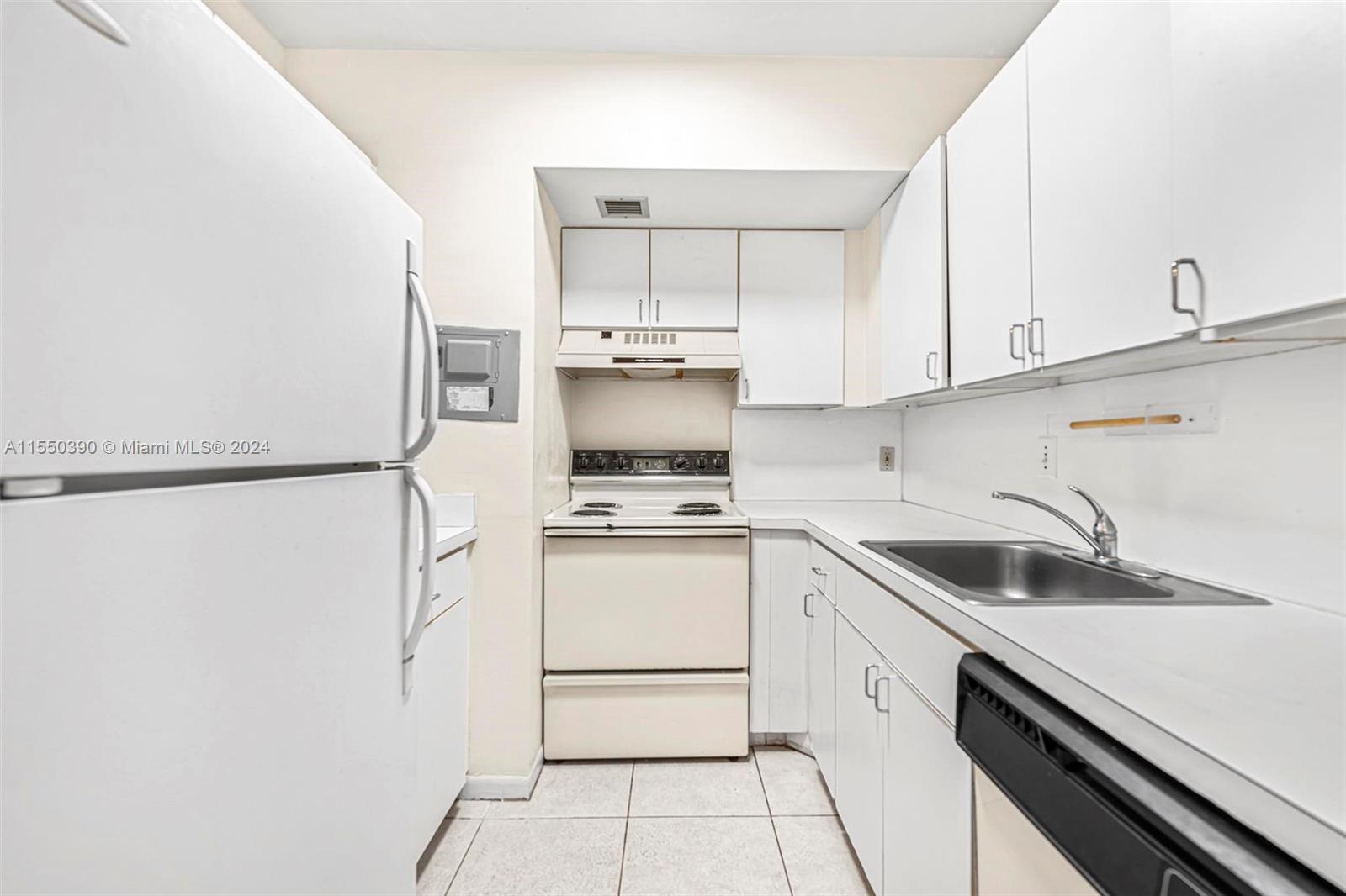 9107 Southwest 137th Terrace, Unit 14 Miami, FL 33186 - Photo 12 of 25 a kitchen with a sink cabinets and stainless steel appliances