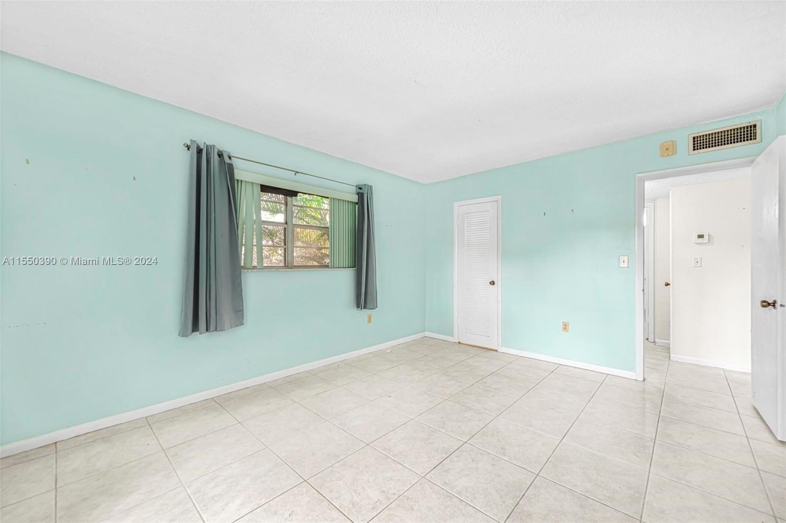 9107 Southwest 137th Terrace, Unit 14 Miami, FL 33186 - Photo 16 of 25 a view of an empty room with window