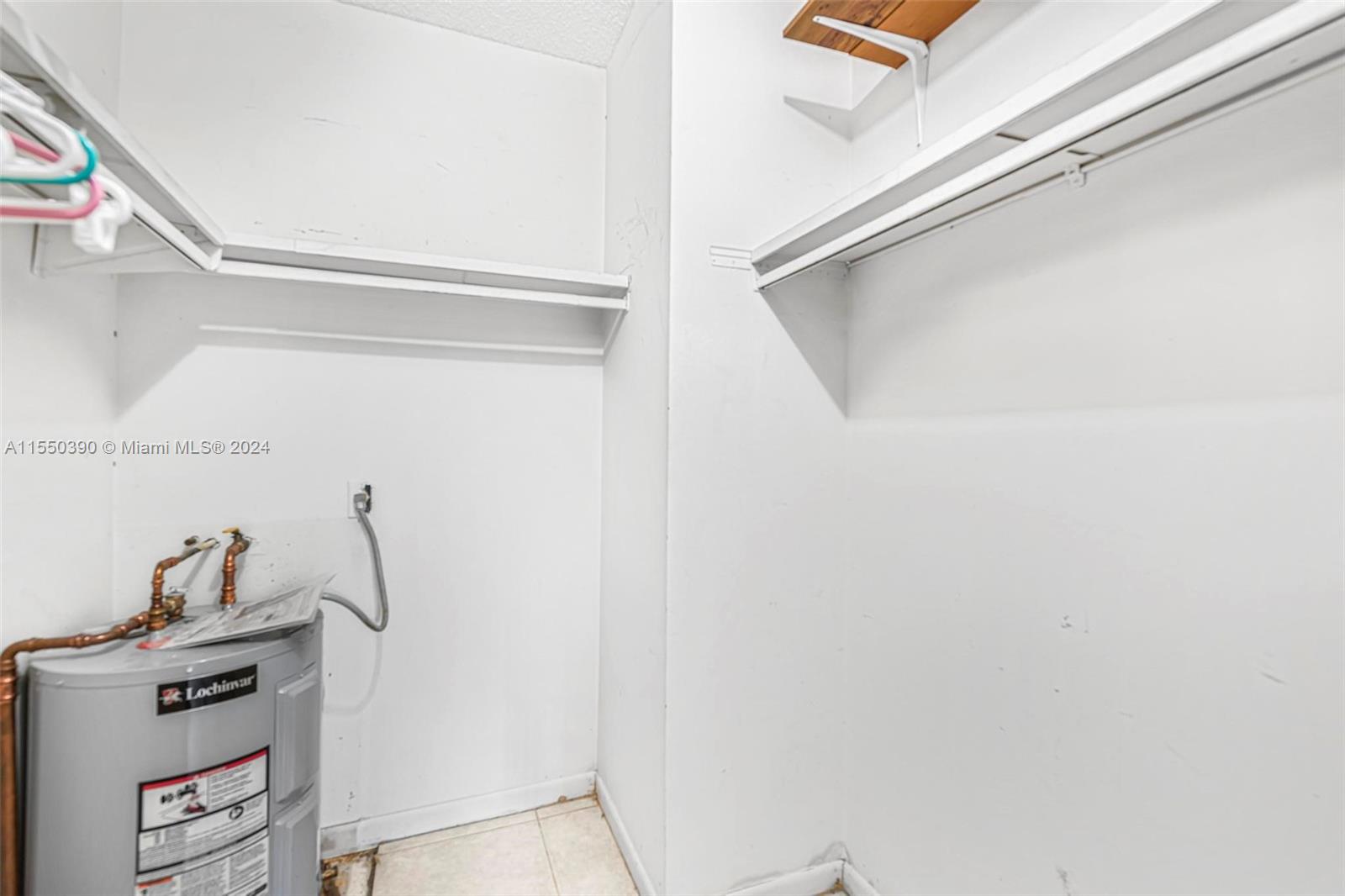 9107 Southwest 137th Terrace, Unit 14 Miami, FL 33186 - Photo 17 of 25 a view of storage and utility room with closet
