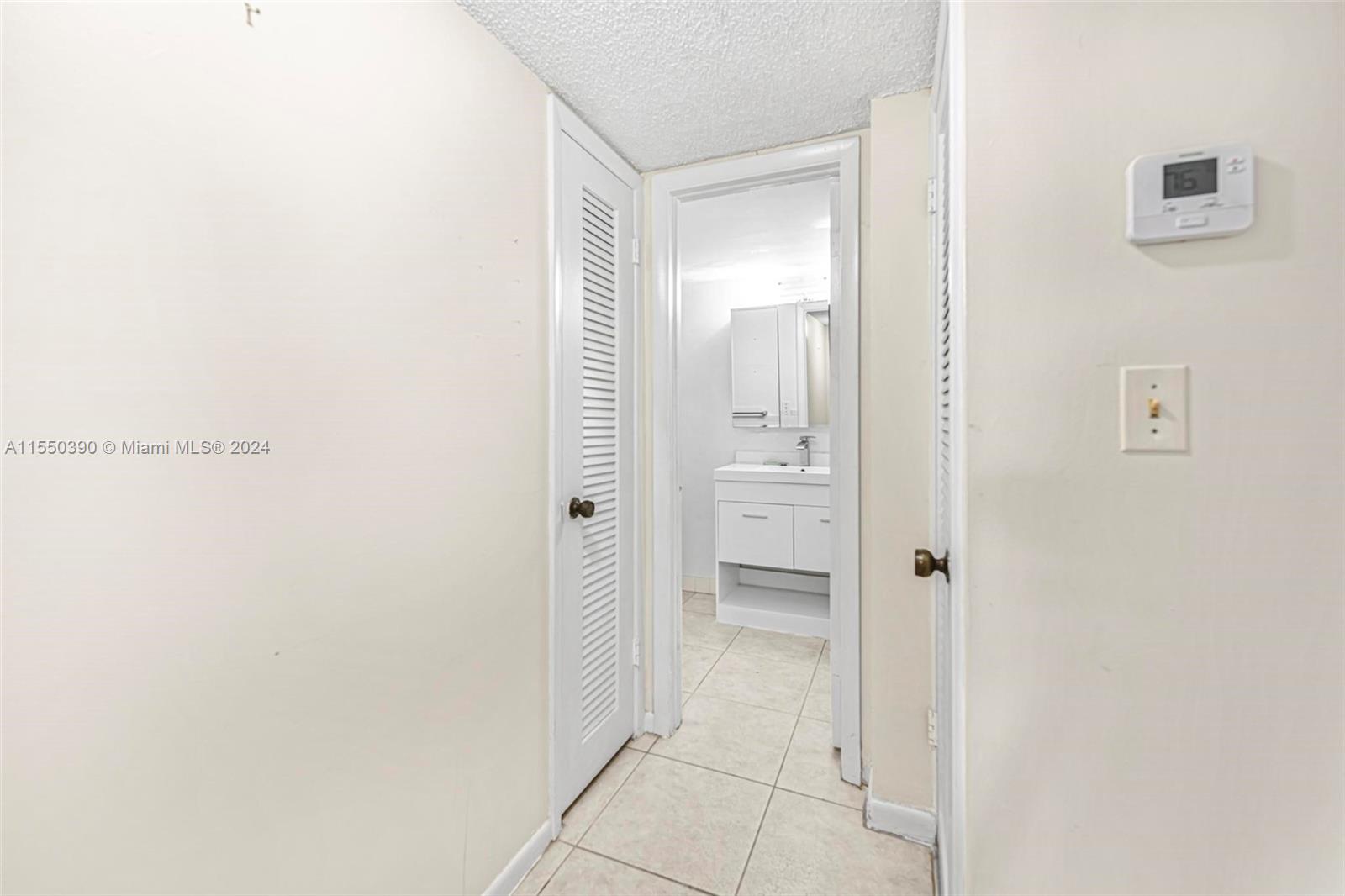 9107 Southwest 137th Terrace, Unit 14 Miami, FL 33186 - Photo 18 of 25 a bathroom with a shower and a sink