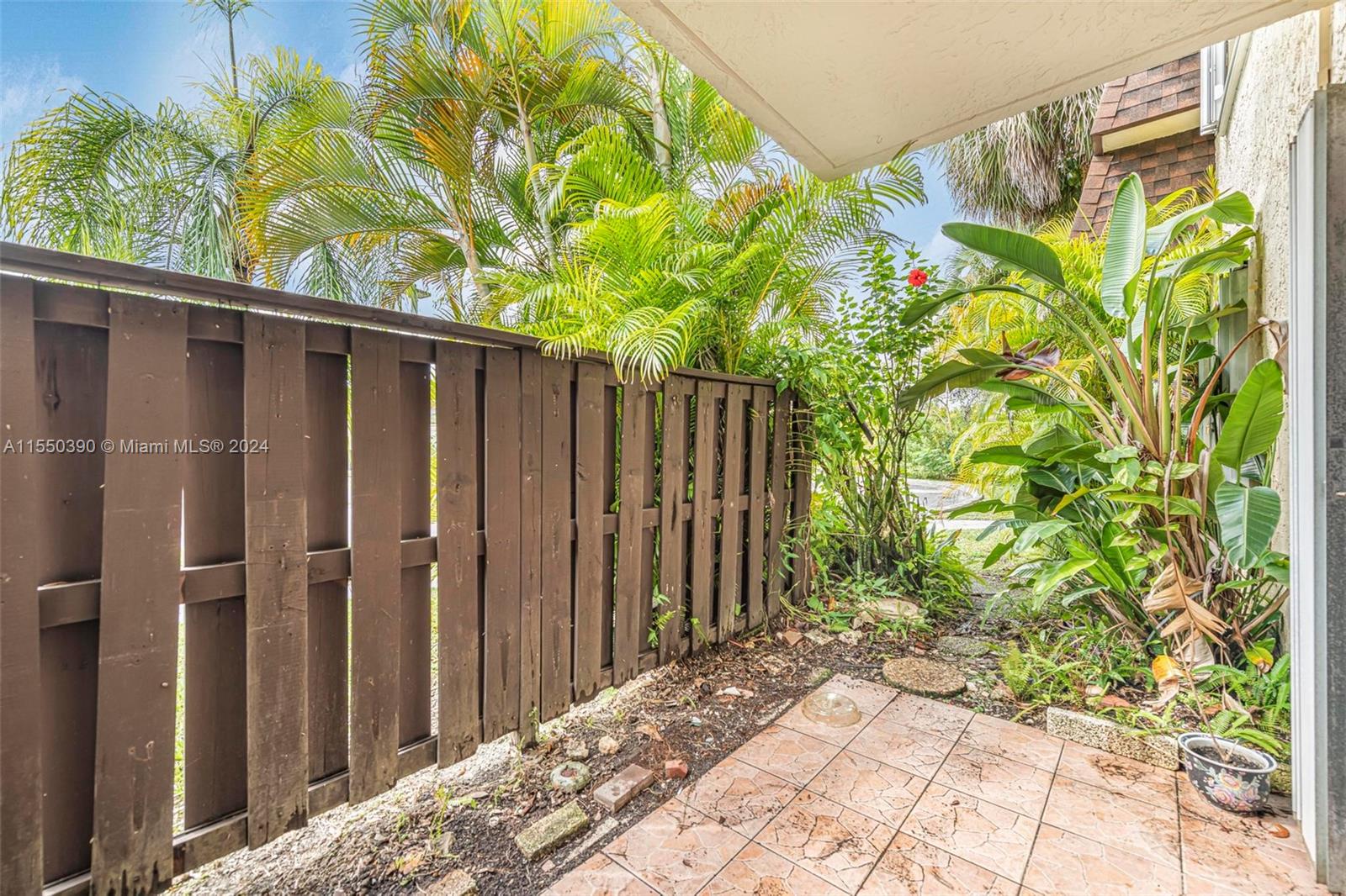 9107 Southwest 137th Terrace, Unit 14 Miami, FL 33186 - Photo 20 of 25 a view of a backyard with plants