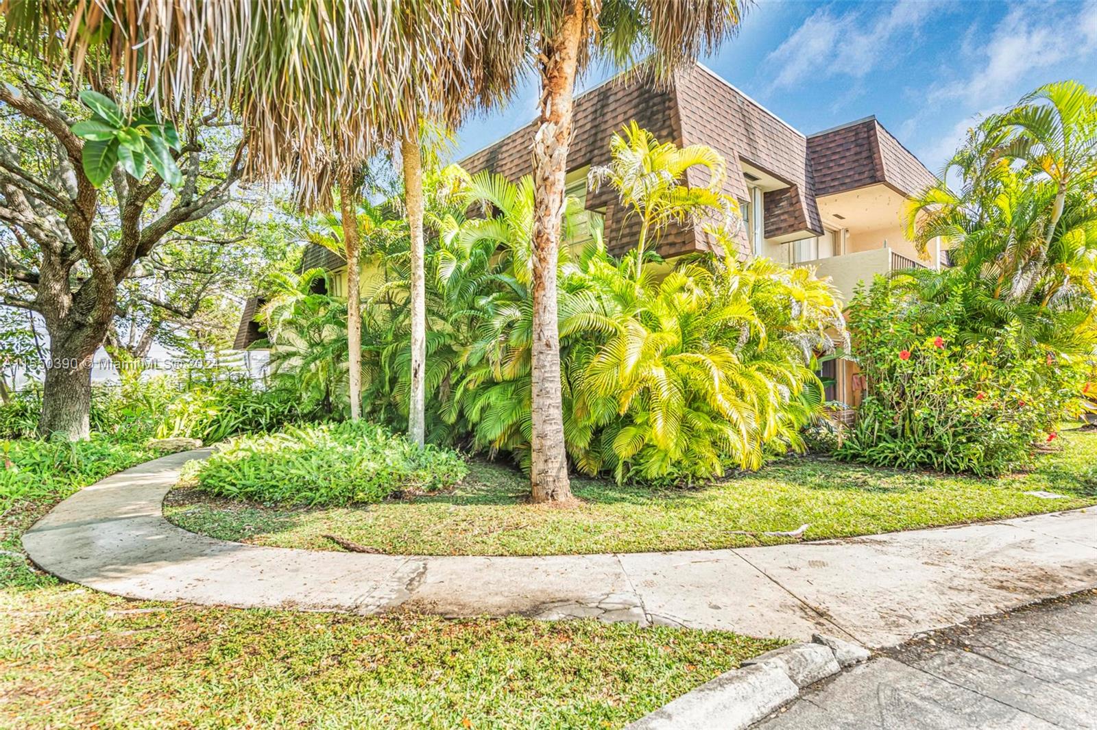 9107 Southwest 137th Terrace, Unit 14 Miami, FL 33186 - Photo 3 of 25 a view of a garden with plants