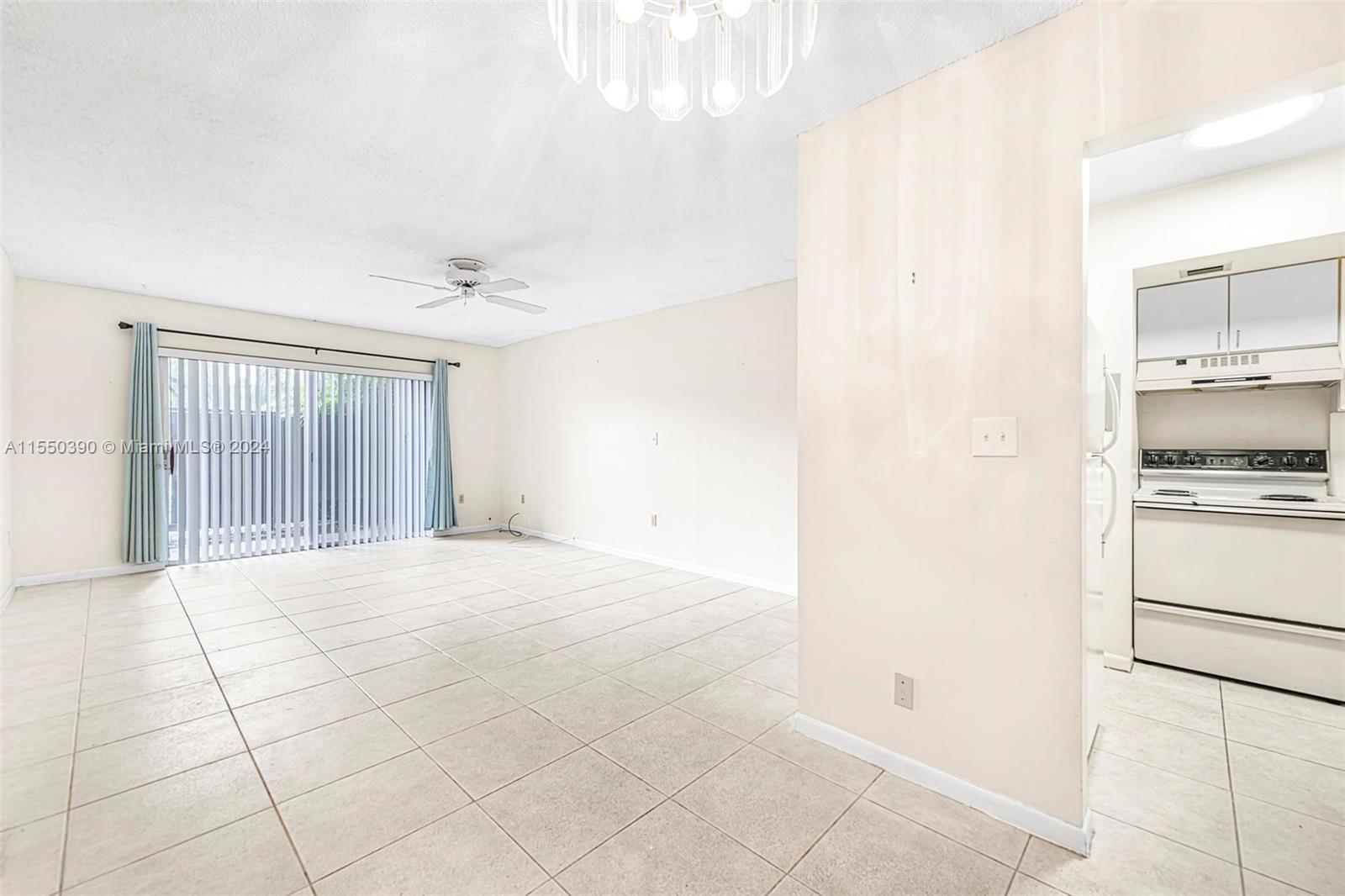 9107 Southwest 137th Terrace, Unit 14 Miami, FL 33186 - Photo 7 of 25 a view of an empty room with a kitchen