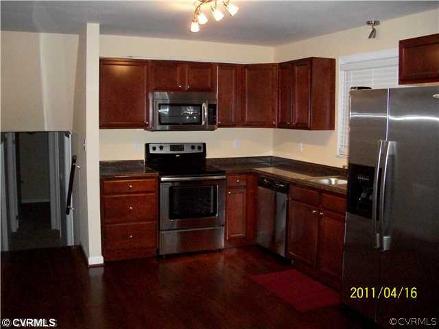 1211 Covington Road Colonial Heights, VA 23834 - Photo 3 of 11 a kitchen with stainless steel appliances granite countertop a refrigerator stove and sink