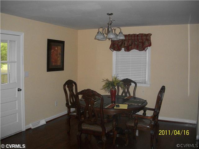 1211 Covington Road Colonial Heights, VA 23834 - Photo 4 of 11 a view of a dining room with furniture and chandelier