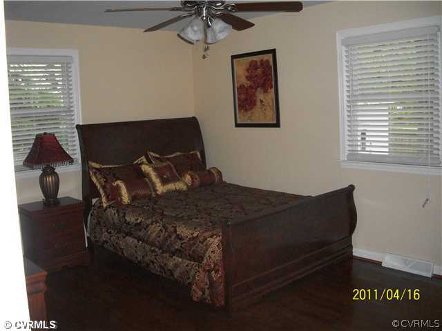 1211 Covington Road Colonial Heights, VA 23834 - Photo 8 of 11 a bed sitting in a bedroom next to a window