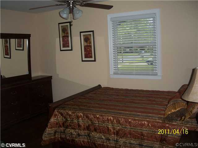 1211 Covington Road Colonial Heights, VA 23834 - Photo 9 of 11 a bedroom with a bed and a window