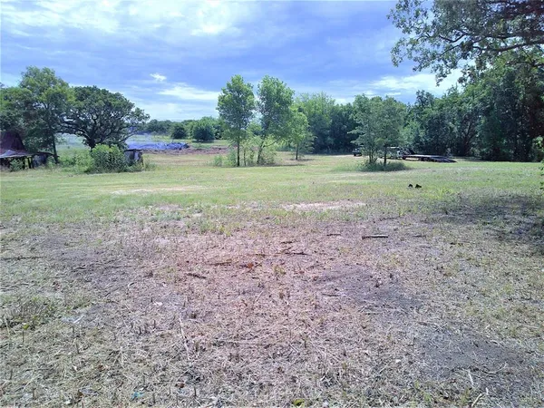 a view of outdoor space with green field and trees