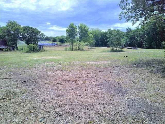 a view of outdoor space with green field and trees