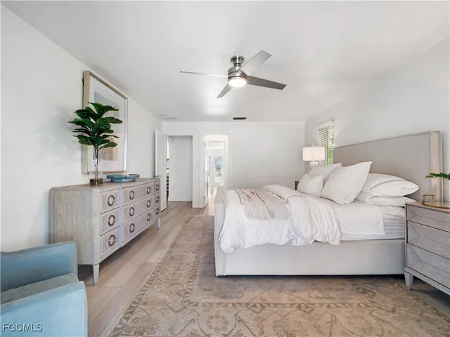 a bathroom with a tub a sink and a large mirror