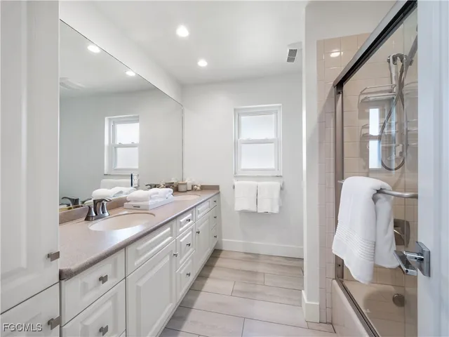 a bedroom with a bed and potted plant