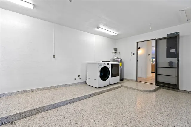 a living room with patio furniture and a garden