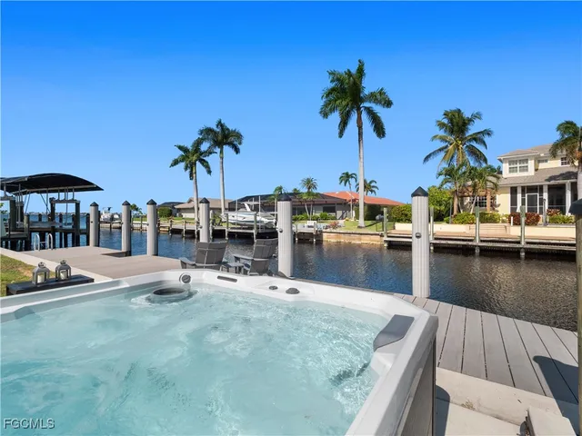 a view of a house with pool and chairs