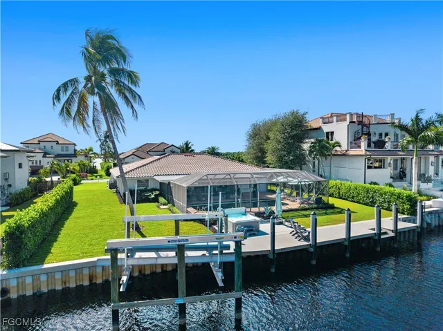 an aerial view of a house with a swimming pool patio and lake view
