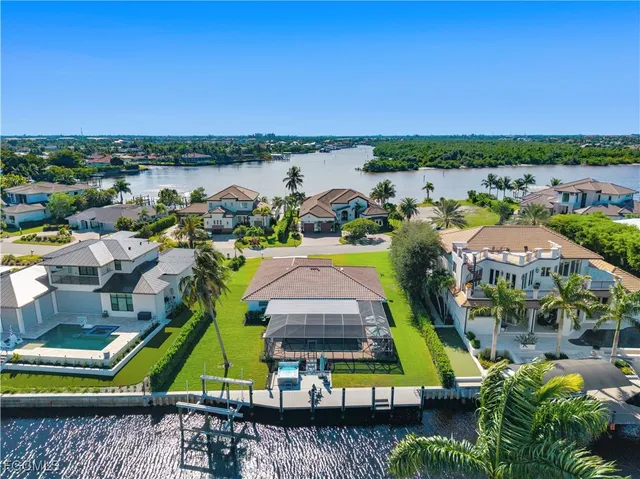 an aerial view of a houses with a lake view