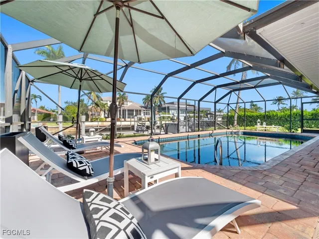 a view of a patio with a table and chairs under an umbrella