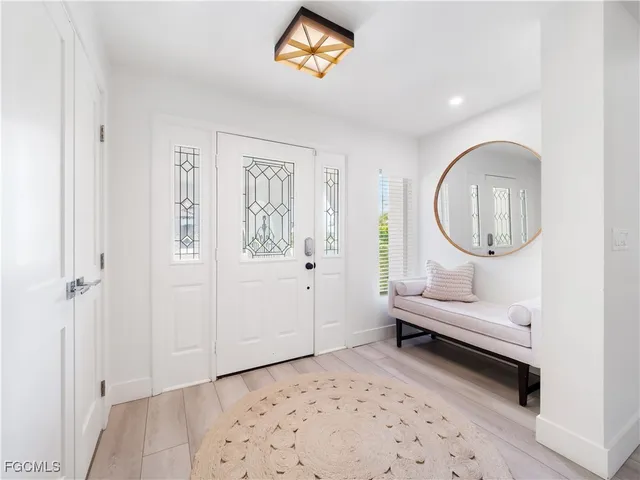 a living room with furniture a rug and a potted plant