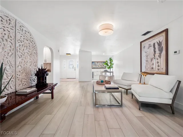 a dining room with furniture and wooden floor