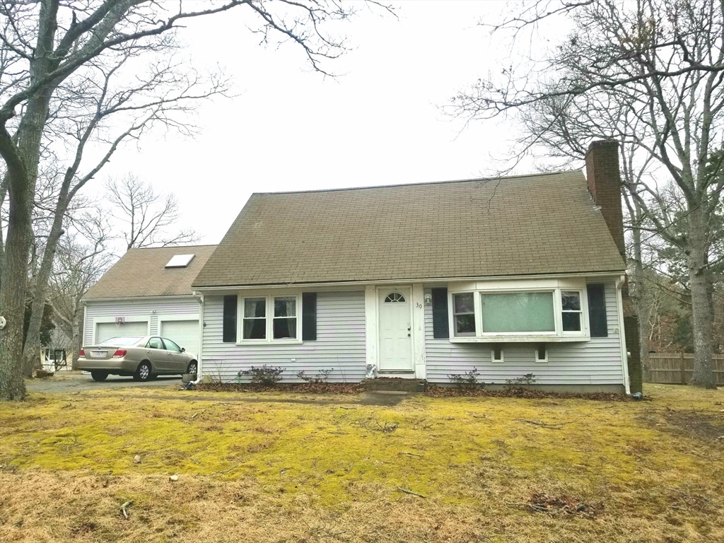 30 Princess Pine Road Hyannis, MA 02601 - Photo 2 of 10 a front view of house with yard and ocean