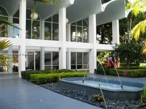 front view of a brick house with a yard