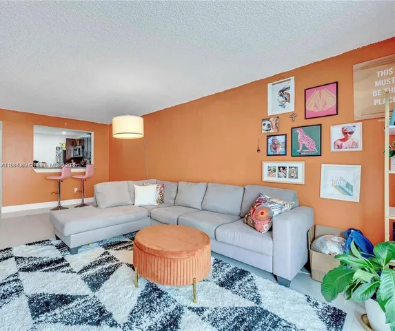 a living room with furniture and painting on the wall