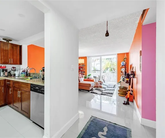 a kitchen with stainless steel appliances granite countertop a refrigerator and a stove