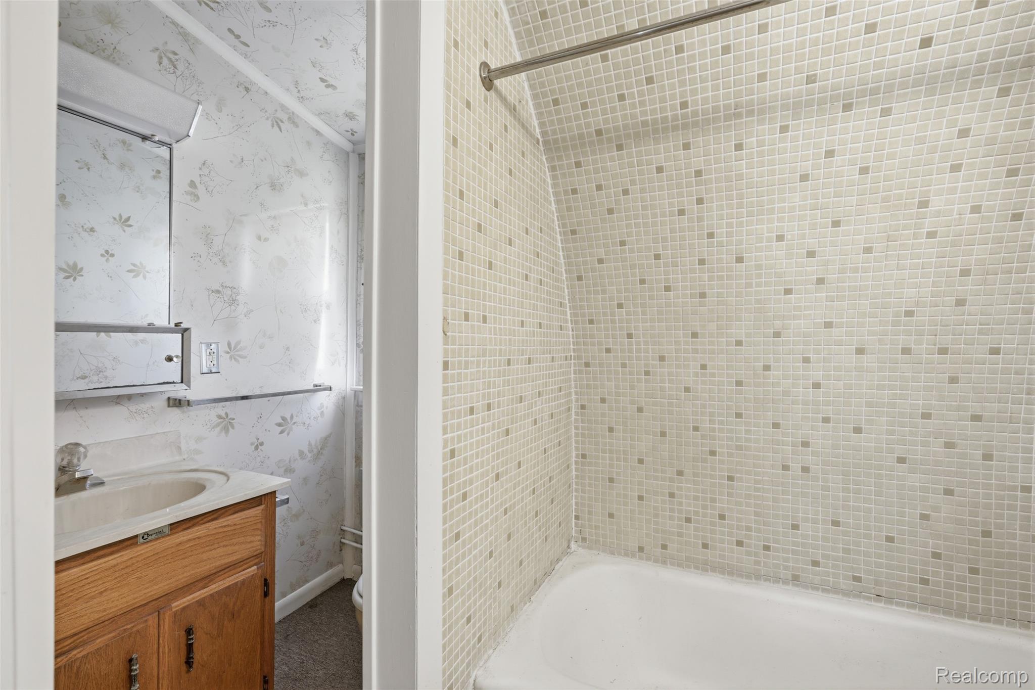 8636 Tindall Road Davisburg, MI 48350 - Photo 52 of 61 Full bath with wallpapered walls, vanity, and bathtub / shower combination