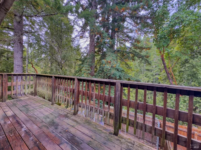 a balcony with wooden floor and fence