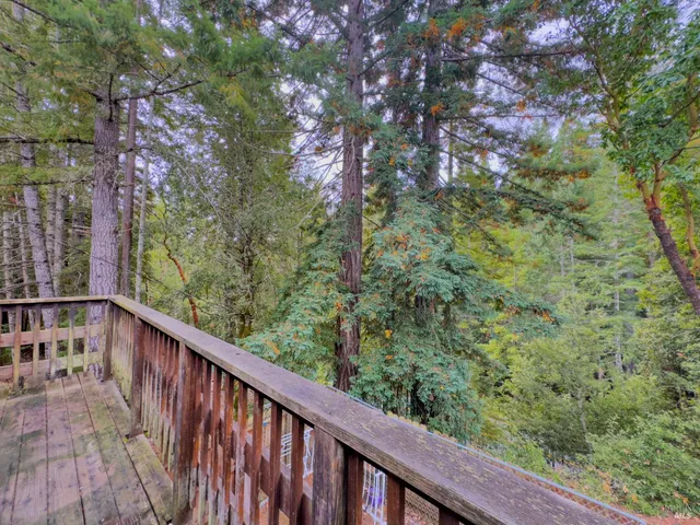 a view of a balcony with wooden fence
