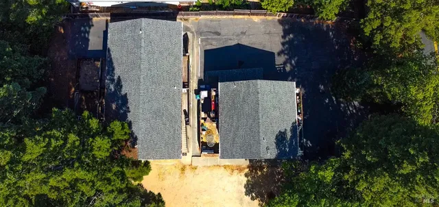 an aerial view of a house with a yard