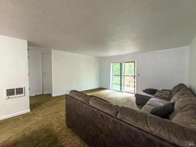 a living room with a couch and a window