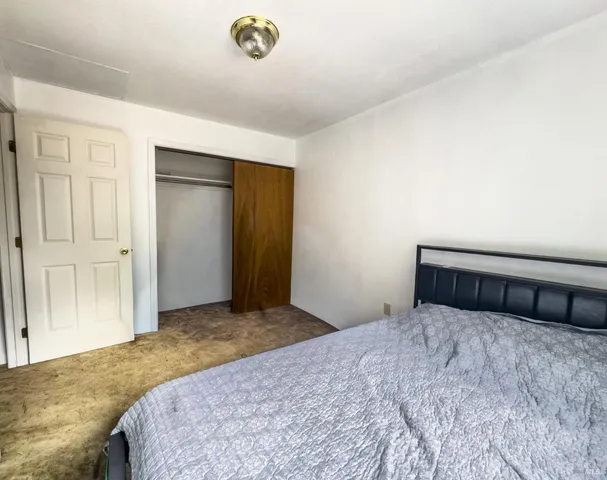 a bedroom with a bed and a cabinets