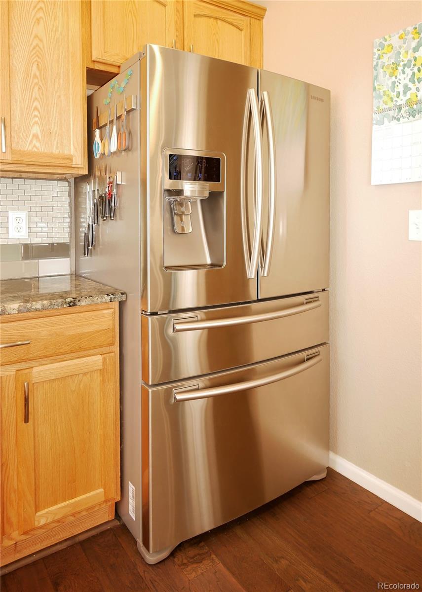 10832 Towerbridge Road Highlands Ranch, CO 80130 - Photo 7 of 31 a close view of a refrigerator a stove and a window