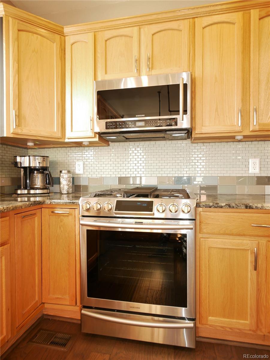 10832 Towerbridge Road Highlands Ranch, CO 80130 - Photo 8 of 31 a stove top oven sitting inside of a kitchen